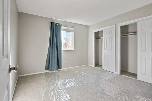 a view of a livingroom with a bedroom and a window