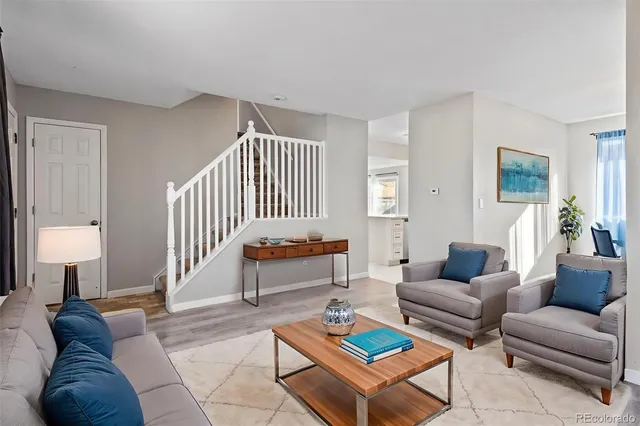 a living room with furniture and a lamp