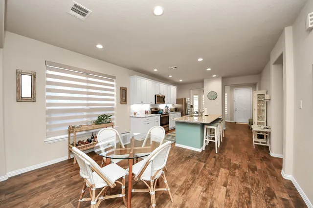 a living room with furniture a flat screen tv and a large window