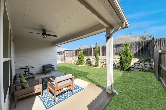 a view of a house with backyard and porch