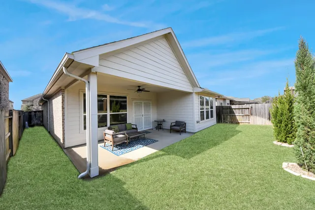 a view of a chairs and table in backyard