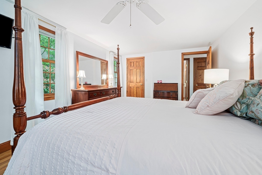 74 Fells Pond Road Mashpee, MA 02649 - Photo 13 of 36 a bedroom with a bed and a large window