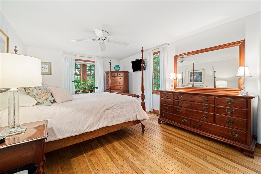 74 Fells Pond Road Mashpee, MA 02649 - Photo 14 of 36 a bedroom with a bed and a large mirror on the dresser