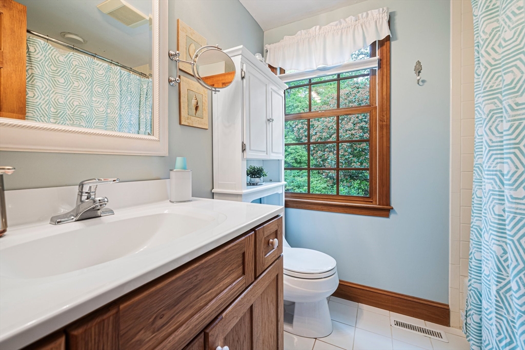 74 Fells Pond Road Mashpee, MA 02649 - Photo 15 of 36 a bathroom with a sink a toilet and a window