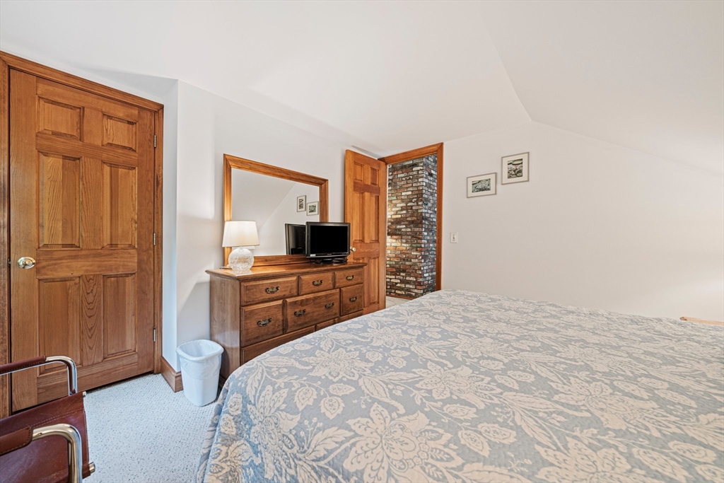 74 Fells Pond Road Mashpee, MA 02649 - Photo 19 of 36 a bedroom with a bed and a flat screen tv