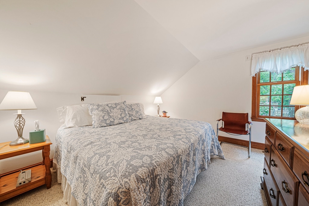 74 Fells Pond Road Mashpee, MA 02649 - Photo 20 of 36 a bedroom with a bed and a lamp