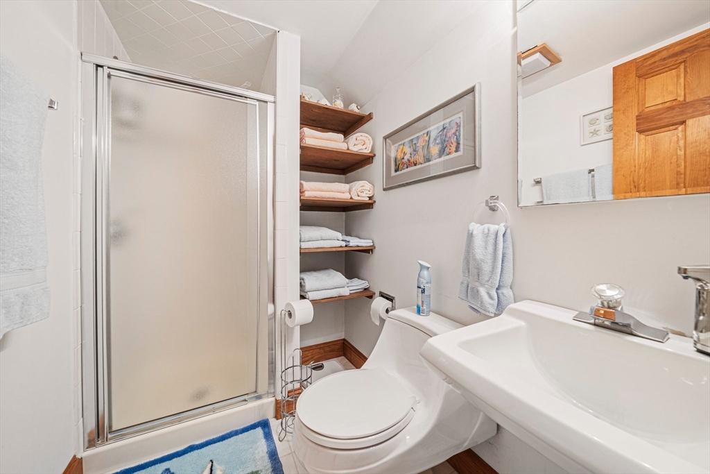 74 Fells Pond Road Mashpee, MA 02649 - Photo 22 of 36 a bathroom with a sink a toilet and shower curtain