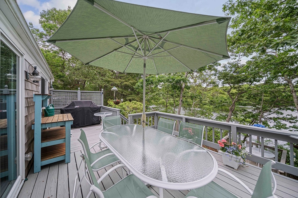74 Fells Pond Road Mashpee, MA 02649 - Photo 23 of 36 a balcony with table and chairs