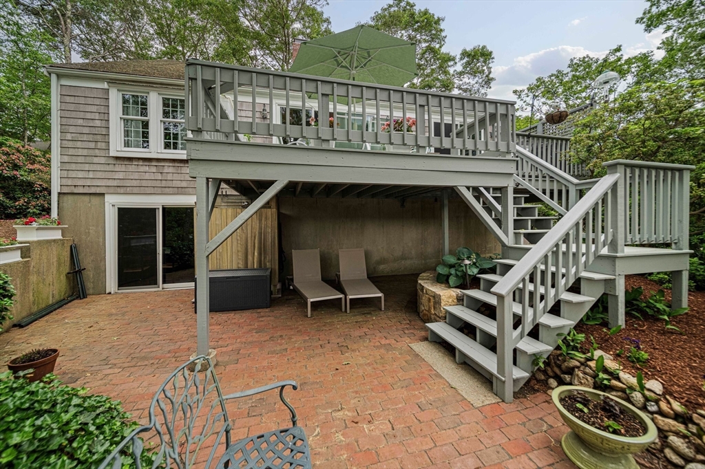 74 Fells Pond Road Mashpee, MA 02649 - Photo 25 of 36 a view of house with deck outdoor seating and entertaining space