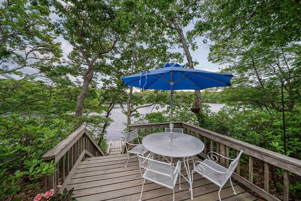 74 Fells Pond Road Mashpee, MA 02649 - Photo 26 of 36 a view of balcony with furniture and umbrella