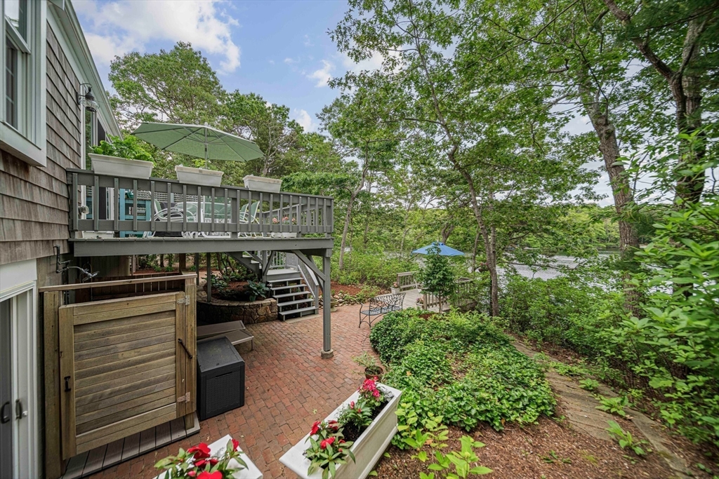 74 Fells Pond Road Mashpee, MA 02649 - Photo 27 of 36 a balcony with outdoor seating and trees
