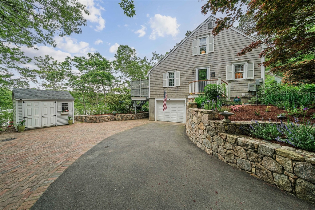 74 Fells Pond Road Mashpee, MA 02649 - Photo 3 of 36 a front view of a house with a yard and garage