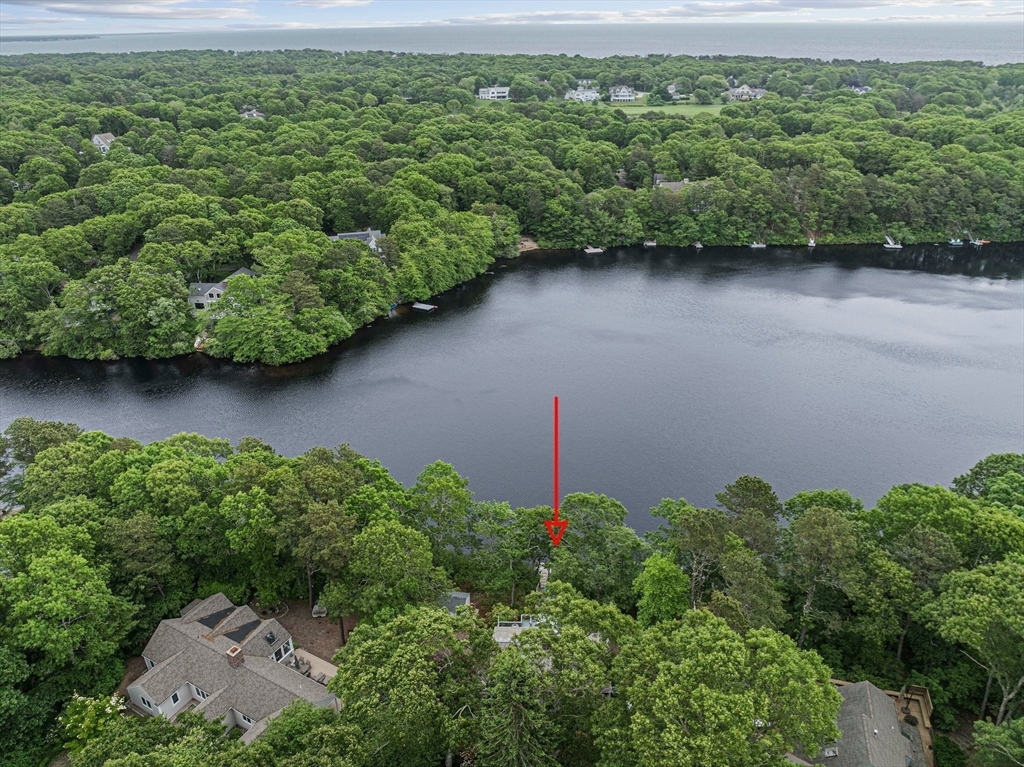 74 Fells Pond Road Mashpee, MA 02649 - Photo 31 of 36 an aerial view of a house with a yard and lake view