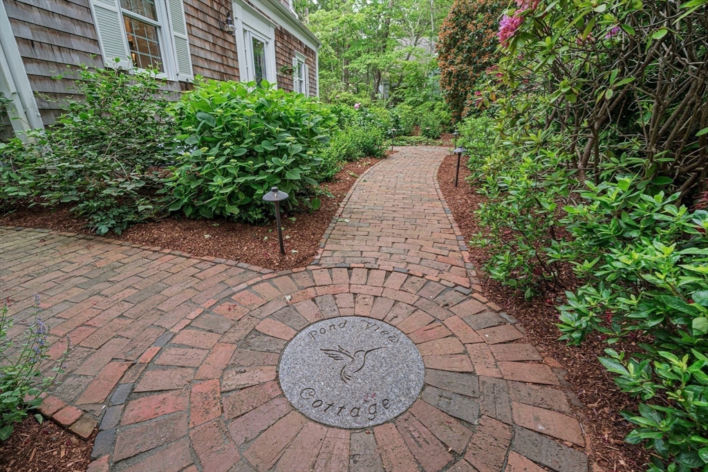 74 Fells Pond Road Mashpee, MA 02649 - Photo 5 of 36 a view of a pathway with a fountain