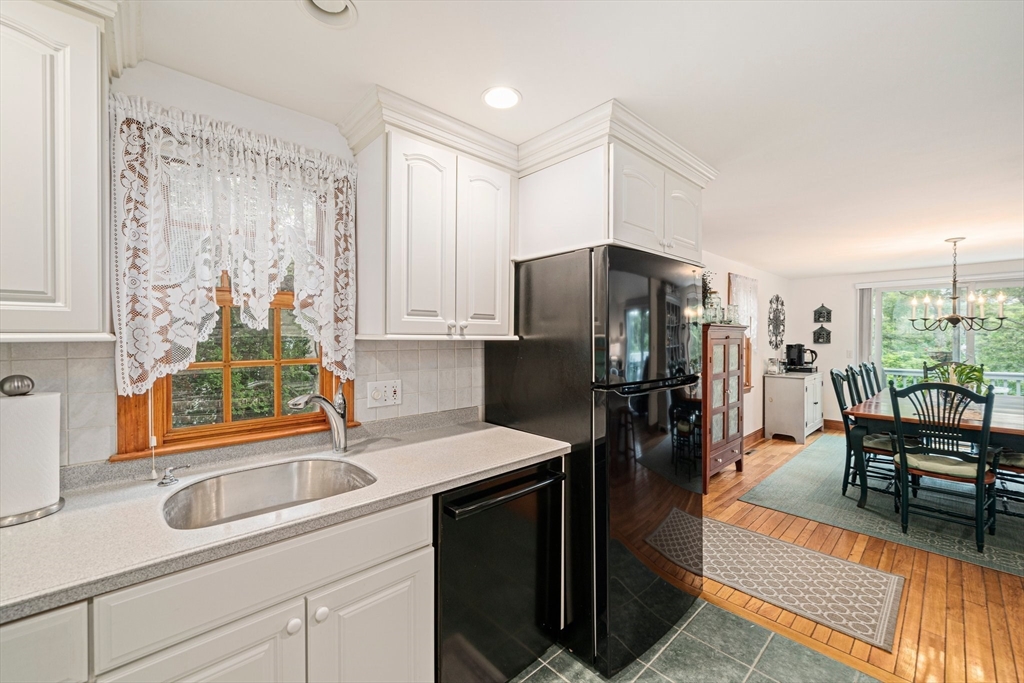 74 Fells Pond Road Mashpee, MA 02649 - Photo 8 of 36 a kitchen with stainless steel appliances a refrigerator a sink a stove and island