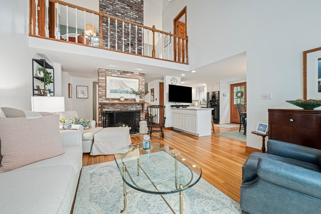 74 Fells Pond Road Mashpee, MA 02649 - Photo 10 of 36 a living room with furniture a fireplace and a flat screen tv