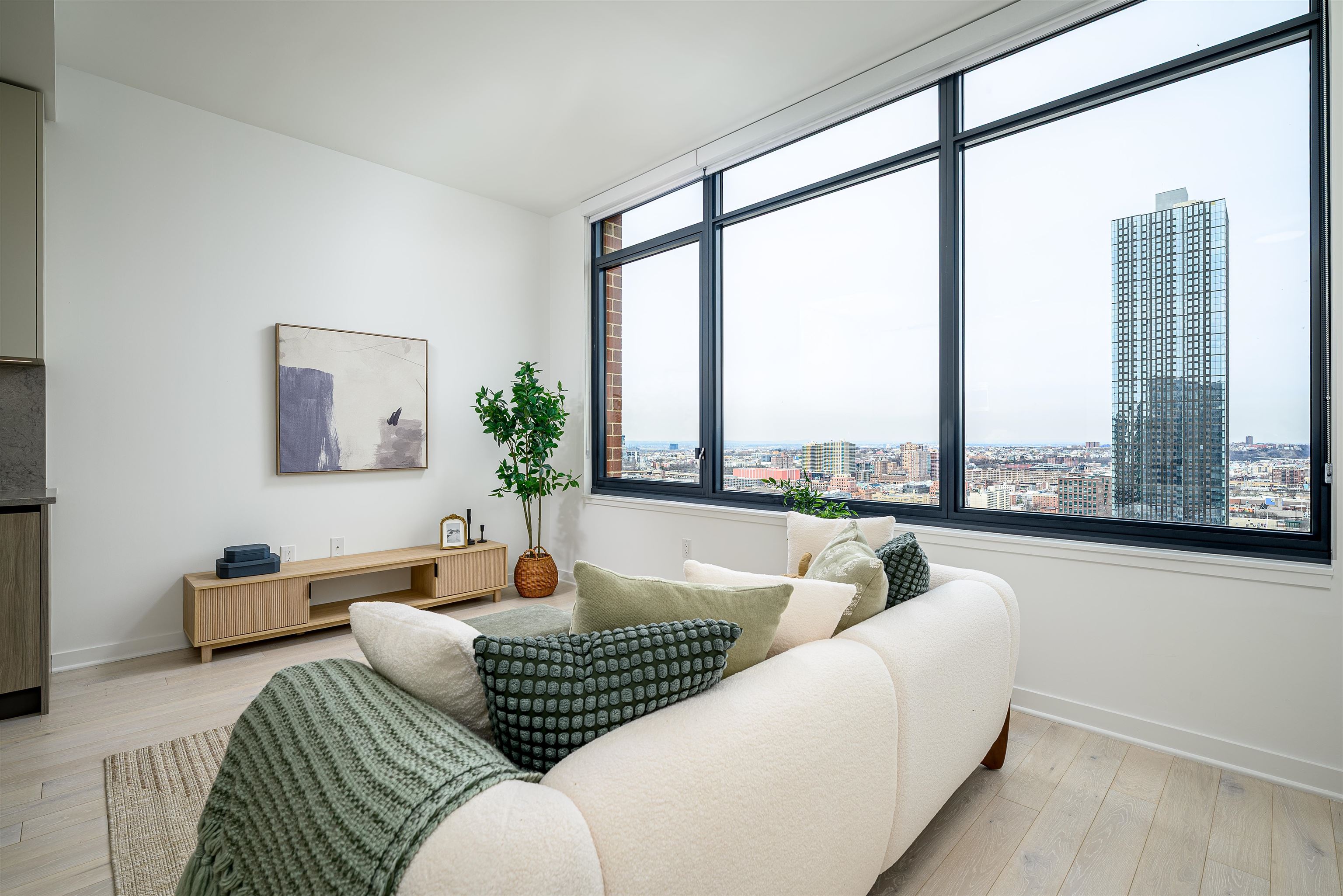155 Bay Street, Unit R3102 Jersey City, NJ 07302 - Photo 3 of 21 a living room with furniture and a large window