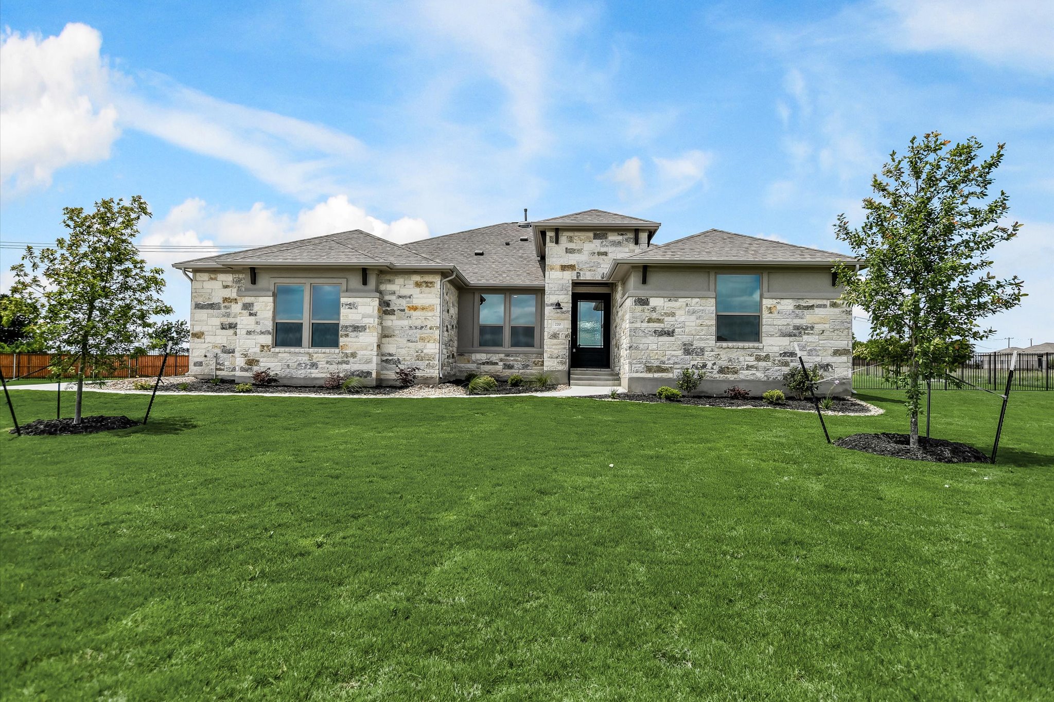 a front view of house with yard and green space