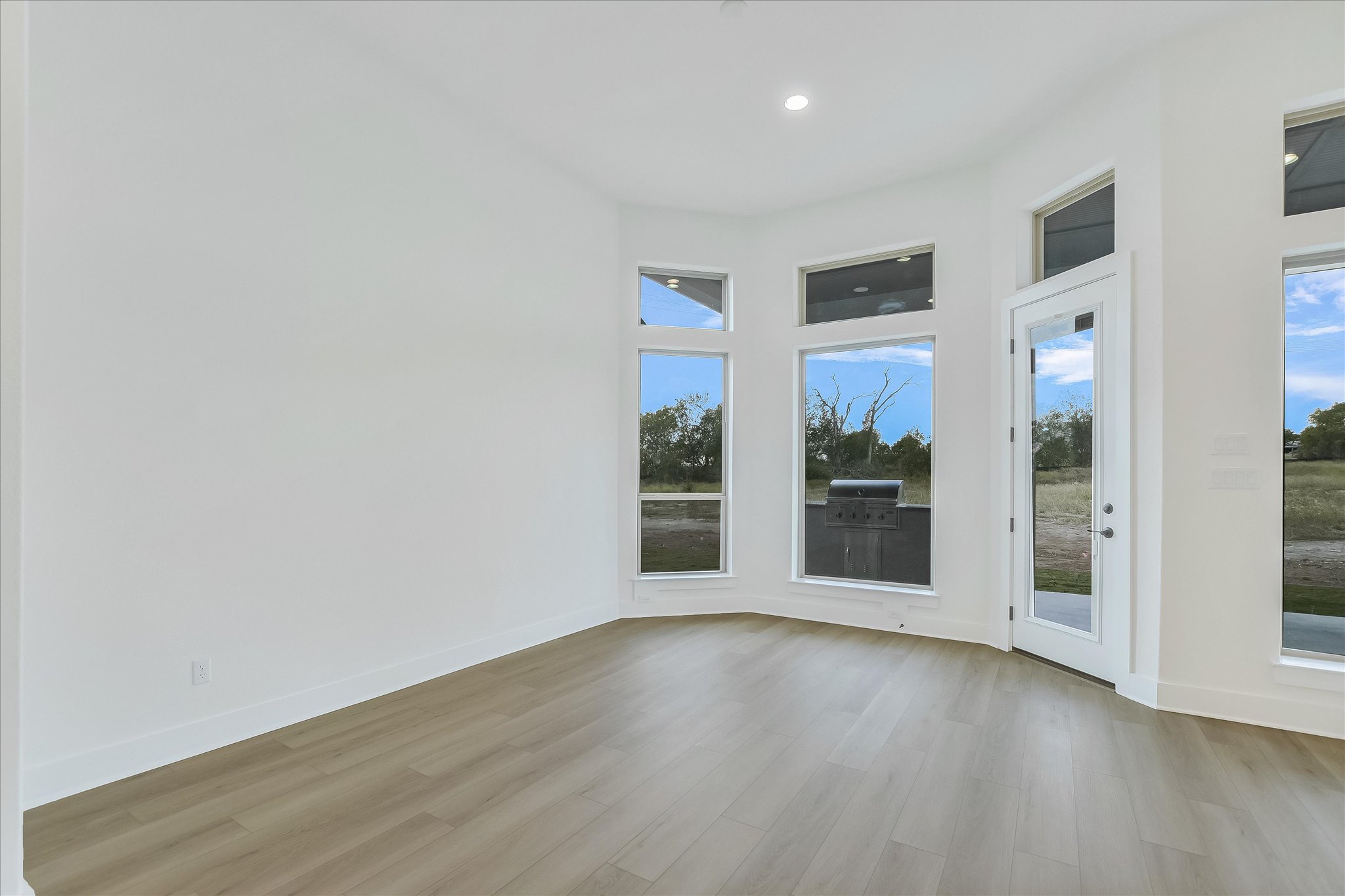220 Scofield Avenue Georgetown, TX 78626 - Photo 11 of 32 an empty room with wooden floor and windows