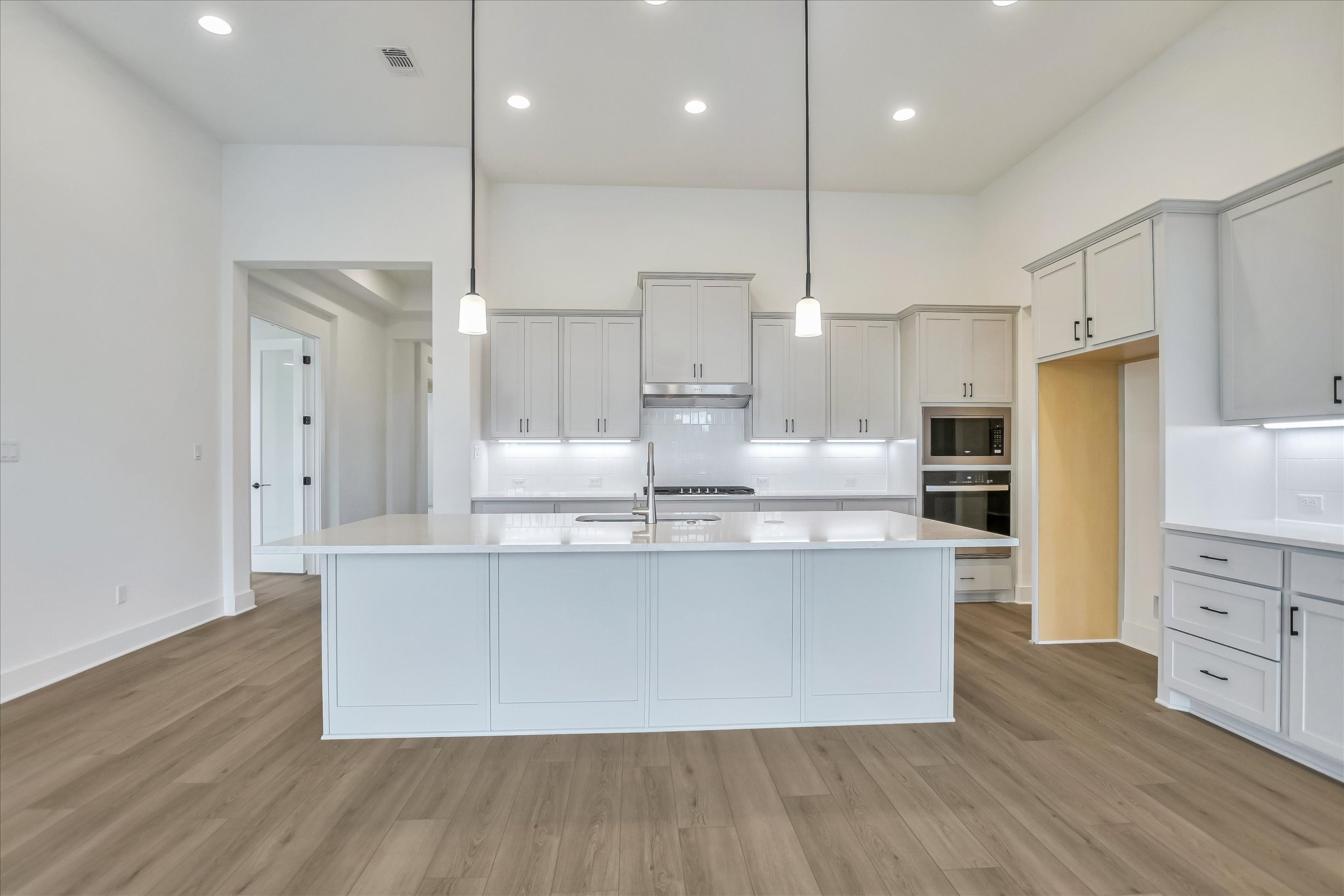 220 Scofield Avenue Georgetown, TX 78626 - Photo 12 of 32 a large kitchen with stainless steel appliances a large counter top a refrigerator a stove and a sink