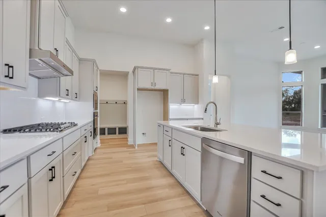 a large kitchen with kitchen island a sink stainless steel appliances and cabinets
