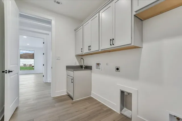 a view of kitchen with white cabinets