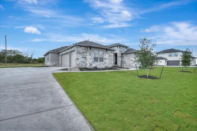 a view of house in front of yard