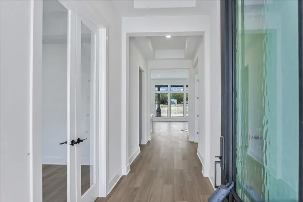 a view of a hallway with wooden floor