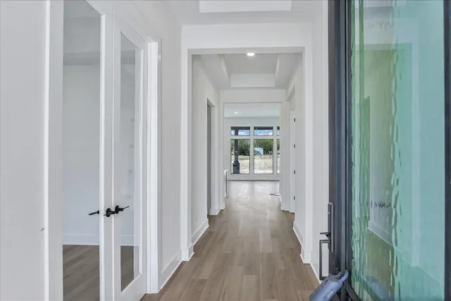 a view of a hallway with wooden floor