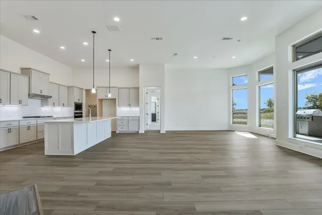 a view of kitchen with kitchen island and stainless steel appliances