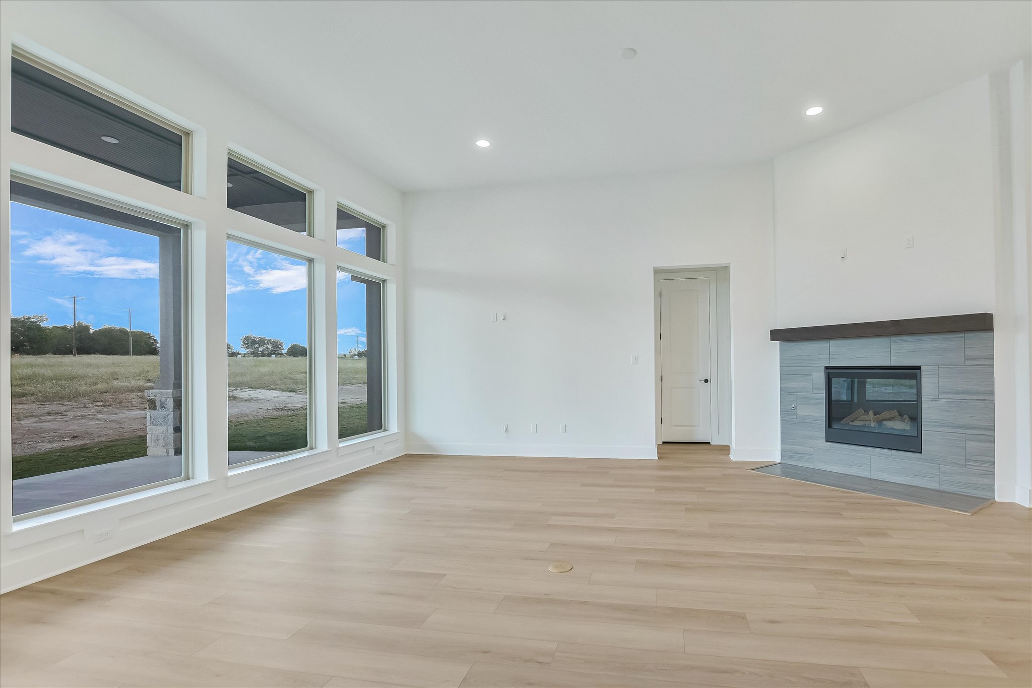 220 Scofield Avenue Georgetown, TX 78626 - Photo 9 of 32 a view of an empty room with a fireplace and window