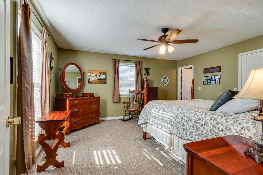 125 Crescent View Cutoff Road Pulaski, TN 38478 - Photo 14 of 30 a bedroom with a bed and a chandelier
