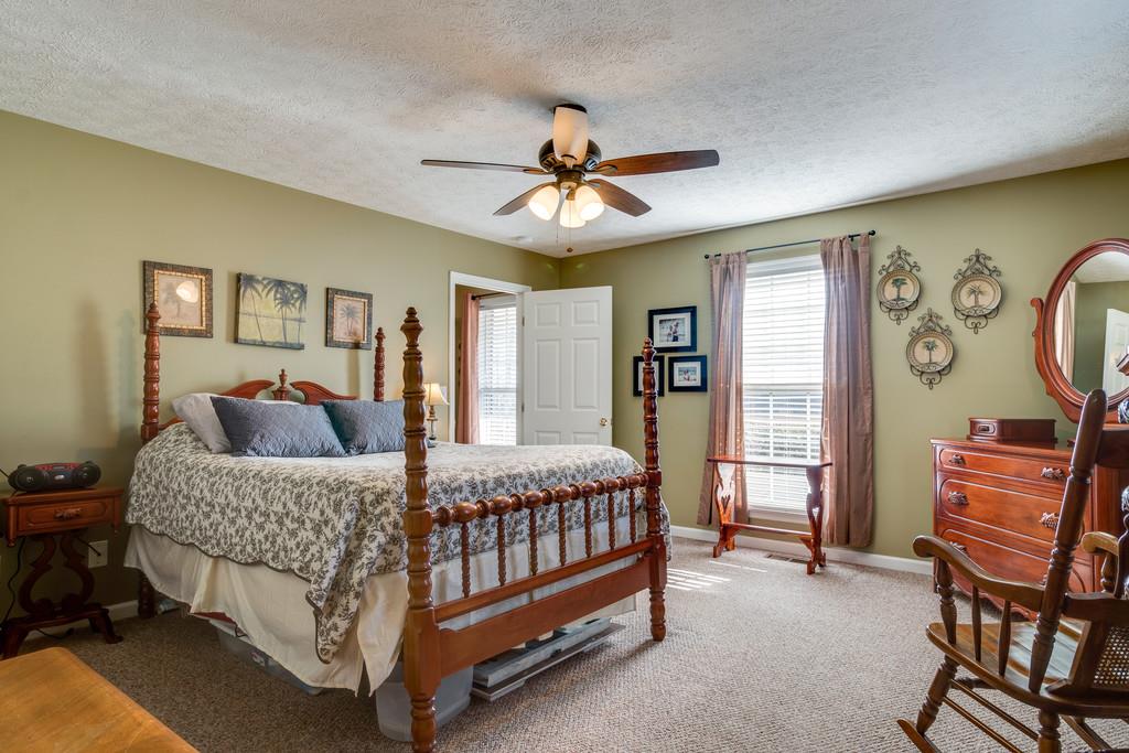 125 Crescent View Cutoff Road Pulaski, TN 38478 - Photo 15 of 30 a bedroom with a bed and a chandelier