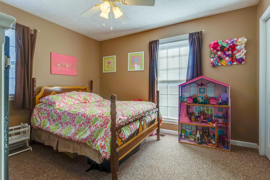 125 Crescent View Cutoff Road Pulaski, TN 38478 - Photo 19 of 30 a bedroom with a bed and a chandelier
