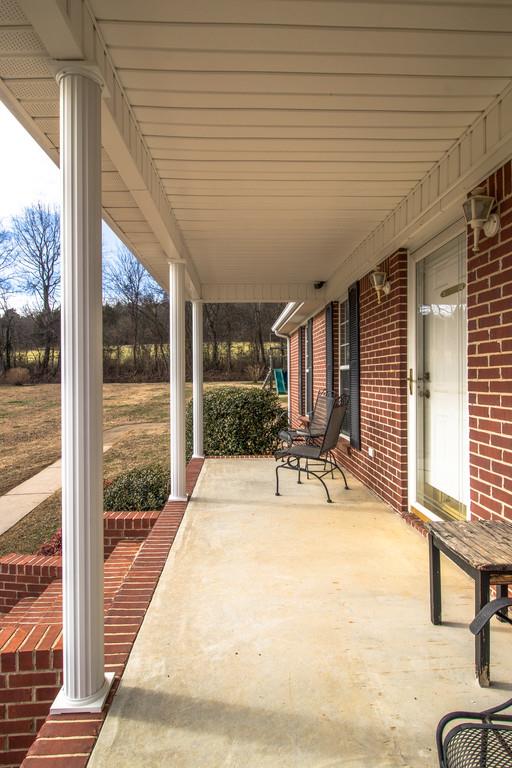 125 Crescent View Cutoff Road Pulaski, TN 38478 - Photo 3 of 30 a view of a patio with a table chairs and wooden fence