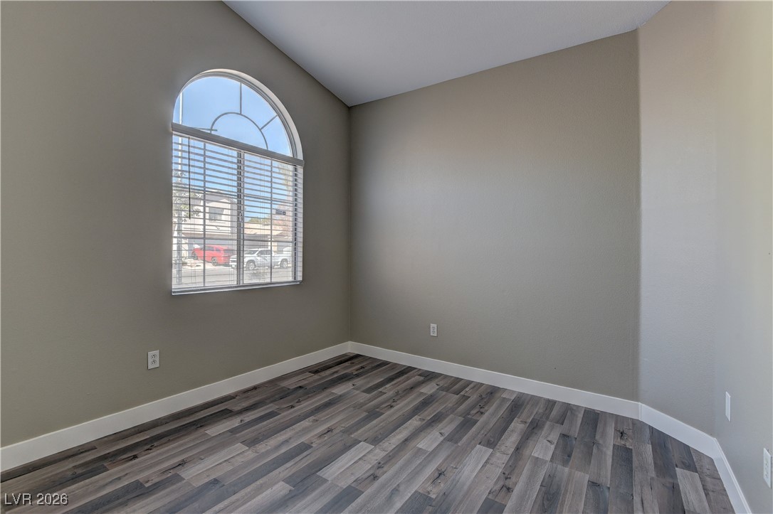 3328 Strawberry Roan Road North Las Vegas, NV 89032 - Photo 11 of 11 Unfurnished room with wood finished floors and lofted ceiling
