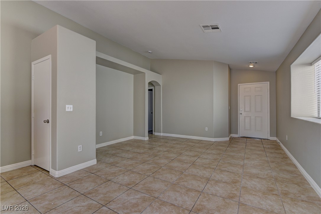 3328 Strawberry Roan Road North Las Vegas, NV 89032 - Photo 4 of 11 Unfurnished room with arched walkways and light tile patterned floors