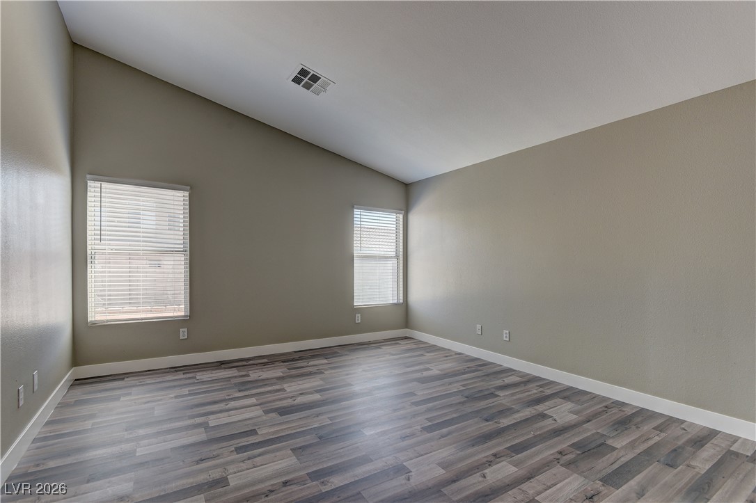 3328 Strawberry Roan Road North Las Vegas, NV 89032 - Photo 8 of 11 Unfurnished room with dark wood finished floors and high vaulted ceiling