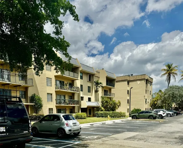 a car parked in front of a white house