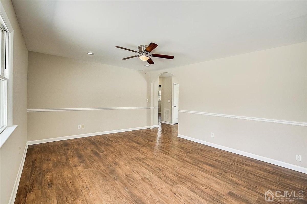 17 Cambridge Road Kendall Park, NJ 08824 - Photo 11 of 28 wooden floor in an empty room with a window