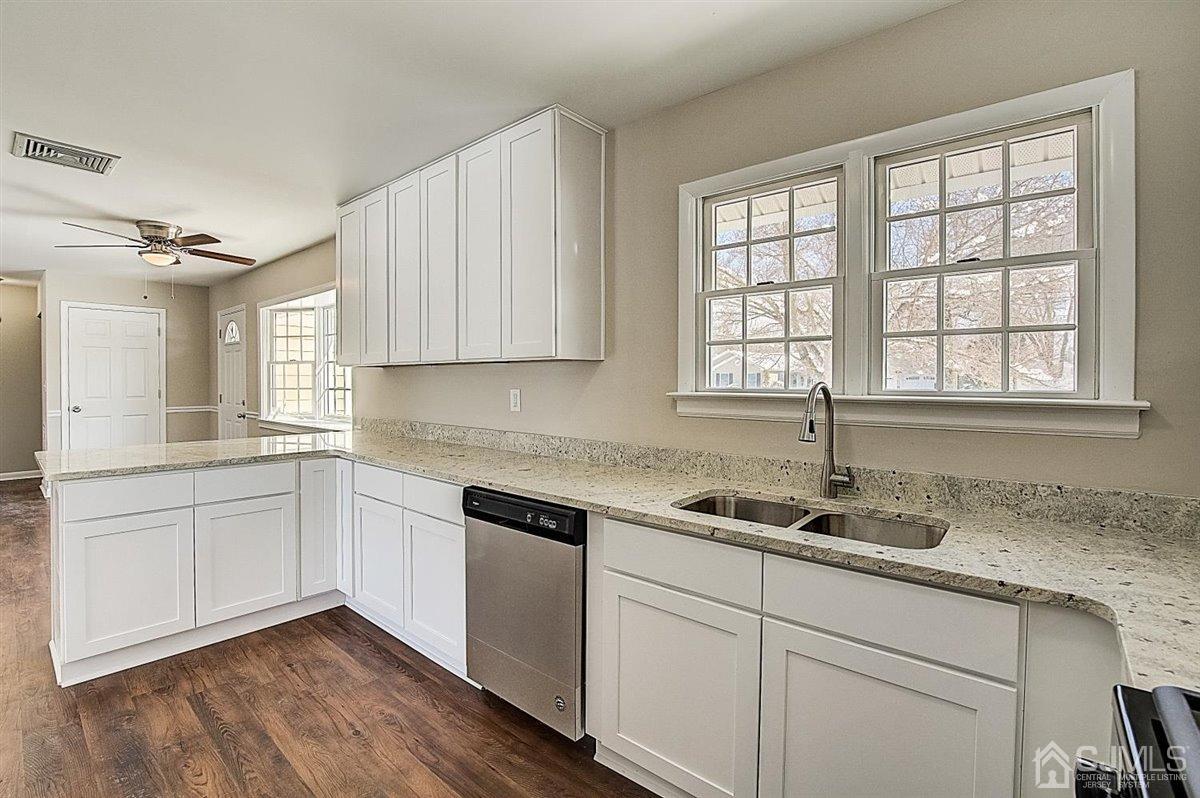 17 Cambridge Road Kendall Park, NJ 08824 - Photo 14 of 28 a kitchen with granite countertop white cabinets and white appliances