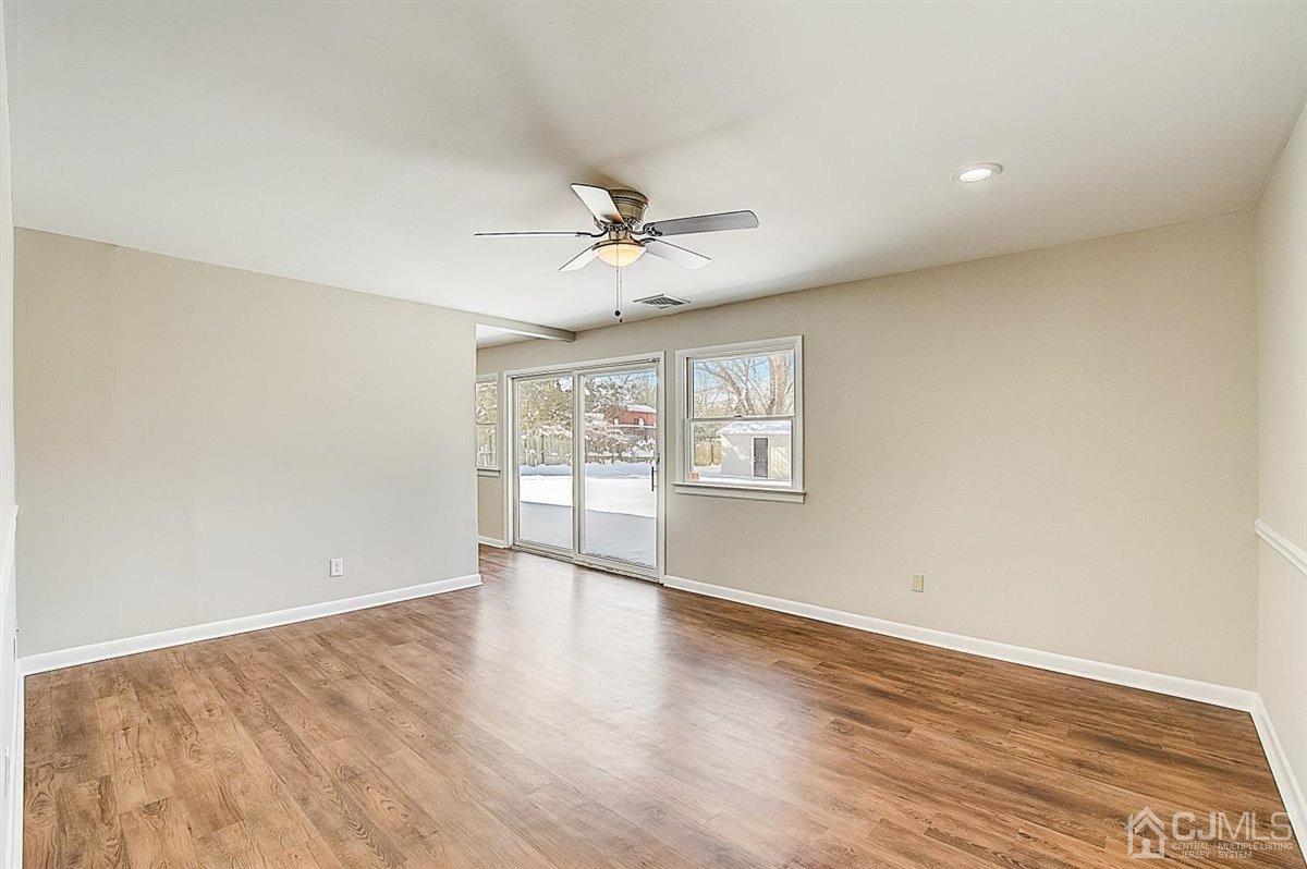 17 Cambridge Road Kendall Park, NJ 08824 - Photo 15 of 28 wooden floor in an empty room with a window