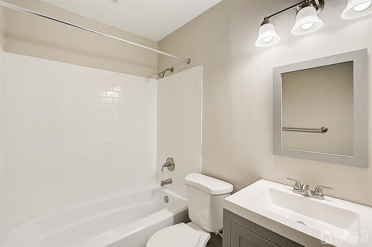 17 Cambridge Road Kendall Park, NJ 08824 - Photo 19 of 28 a bathroom with a sink toilet and shower