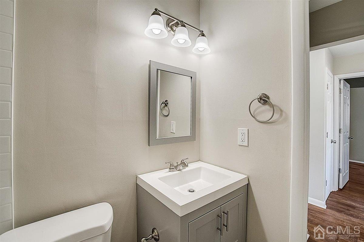 17 Cambridge Road Kendall Park, NJ 08824 - Photo 20 of 28 a bathroom with a toilet sink and mirror