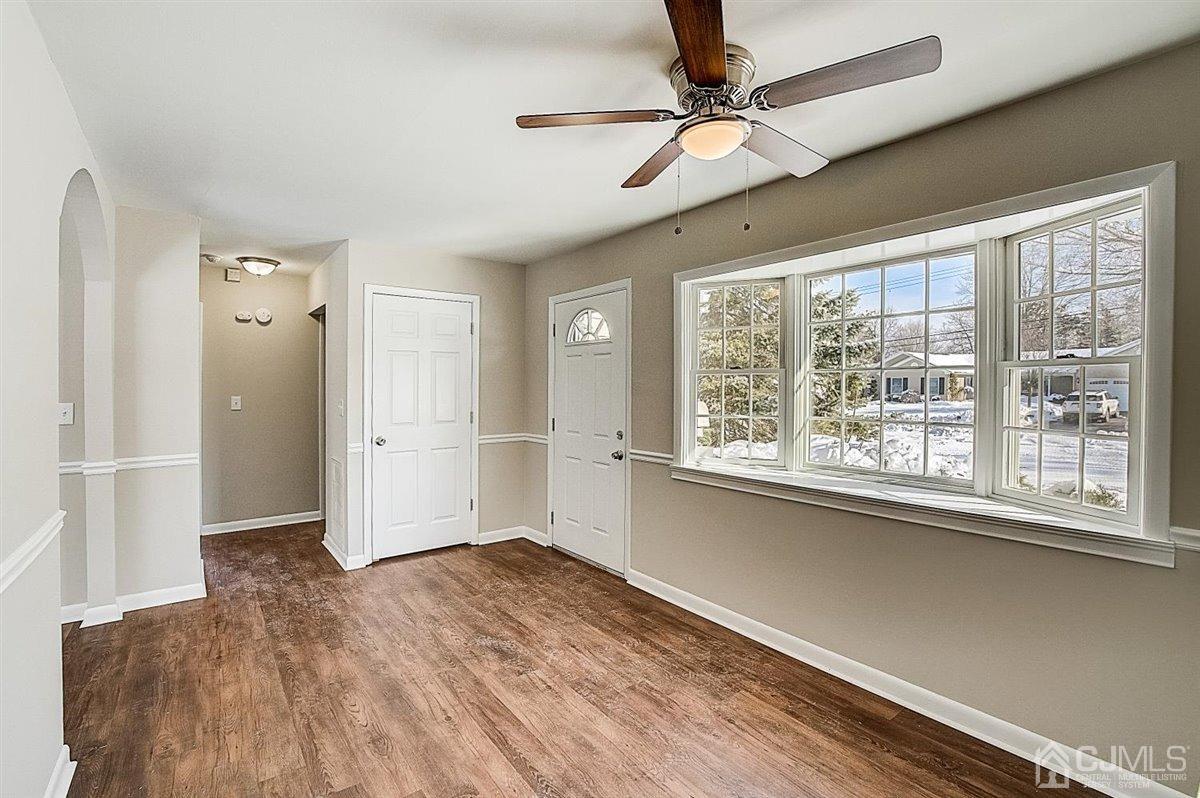 17 Cambridge Road Kendall Park, NJ 08824 - Photo 4 of 28 a view of empty room with wooden floor and fan