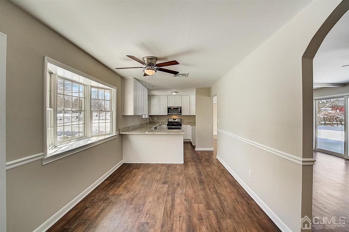 17 Cambridge Road Kendall Park, NJ 08824 - Photo 6 of 28 a view of a kitchen with a sink and dishwasher with wooden floor