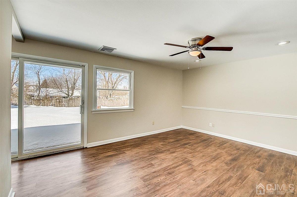 17 Cambridge Road Kendall Park, NJ 08824 - Photo 9 of 28 a view of empty room with wooden floor and fan