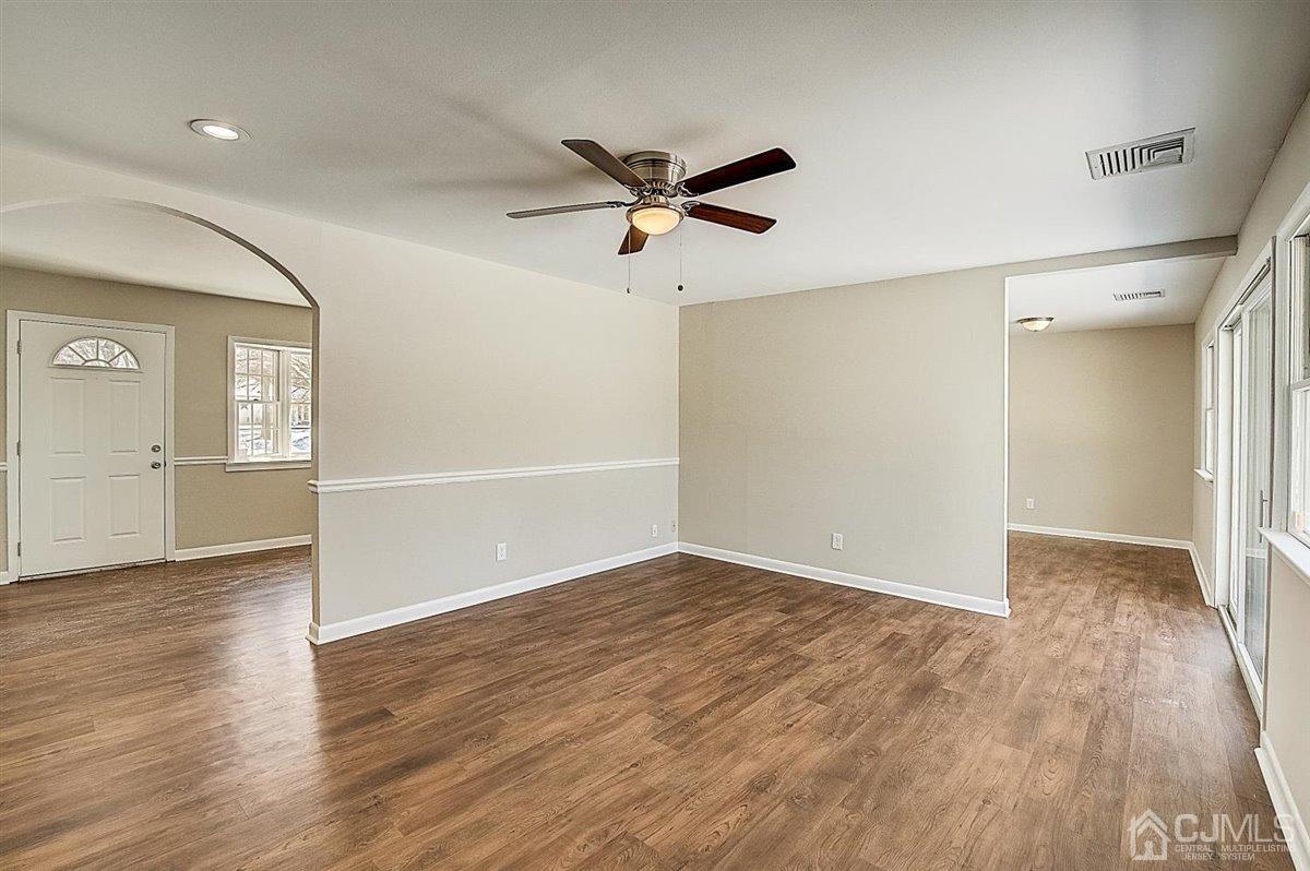 17 Cambridge Road Kendall Park, NJ 08824 - Photo 10 of 28 wooden floor in an empty room with a window