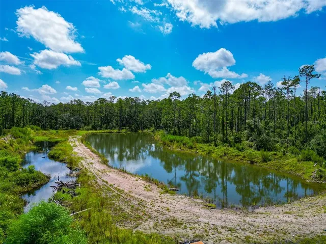 a view of a lake in between two of trees