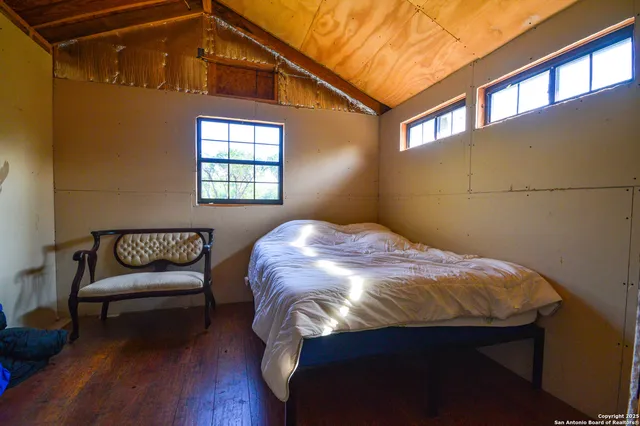 a bedroom with a bed and window